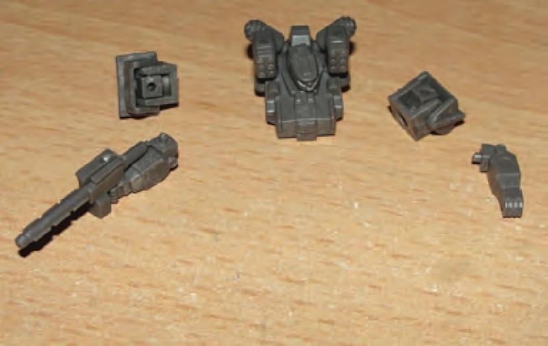 Glue head/v-engine/MRPs to torso. Clip off gun handle & glue gun to hand/arm in desired pose.