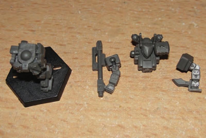 Glue legs & butt plate to hips in desired pose then glue hip armor plates/ammo clip/box on legs/hips and then glue legs on base. Prepare torso and arms in desired pose.